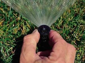 our Sprinkler Repair techs adjust pop up heads